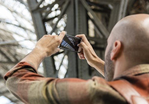 A person captures a photo of industrial machinery, highlighting the expertise of a Machinery Parts Supplier.